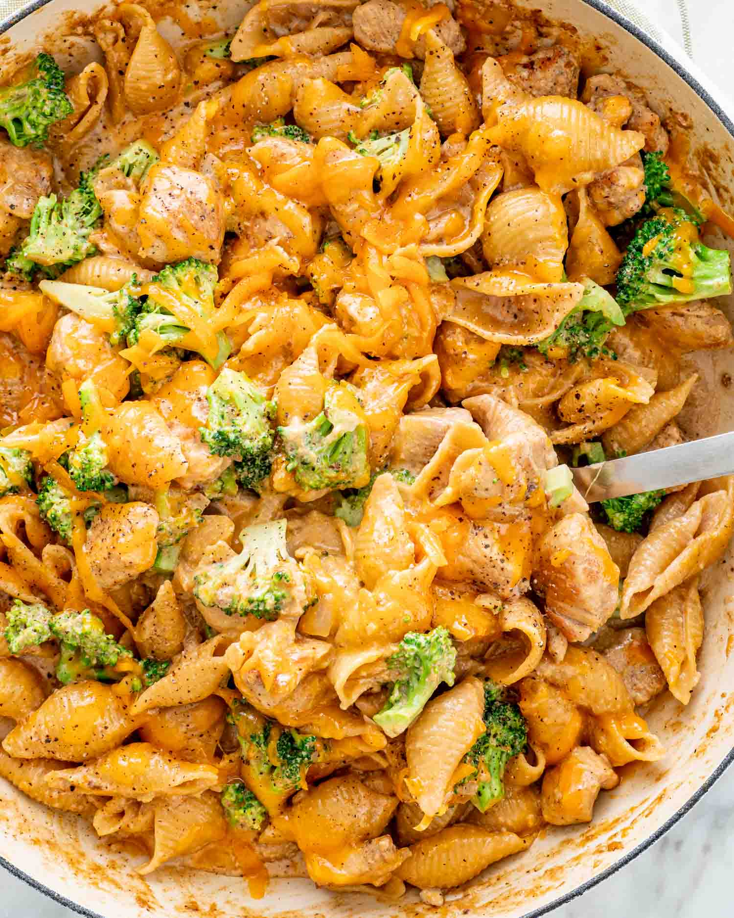 cheesy chicken broccoli pasta in a skillet freshly made.