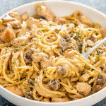 chicken tetrazzini garnished with parmesan cheese in a white bowl.