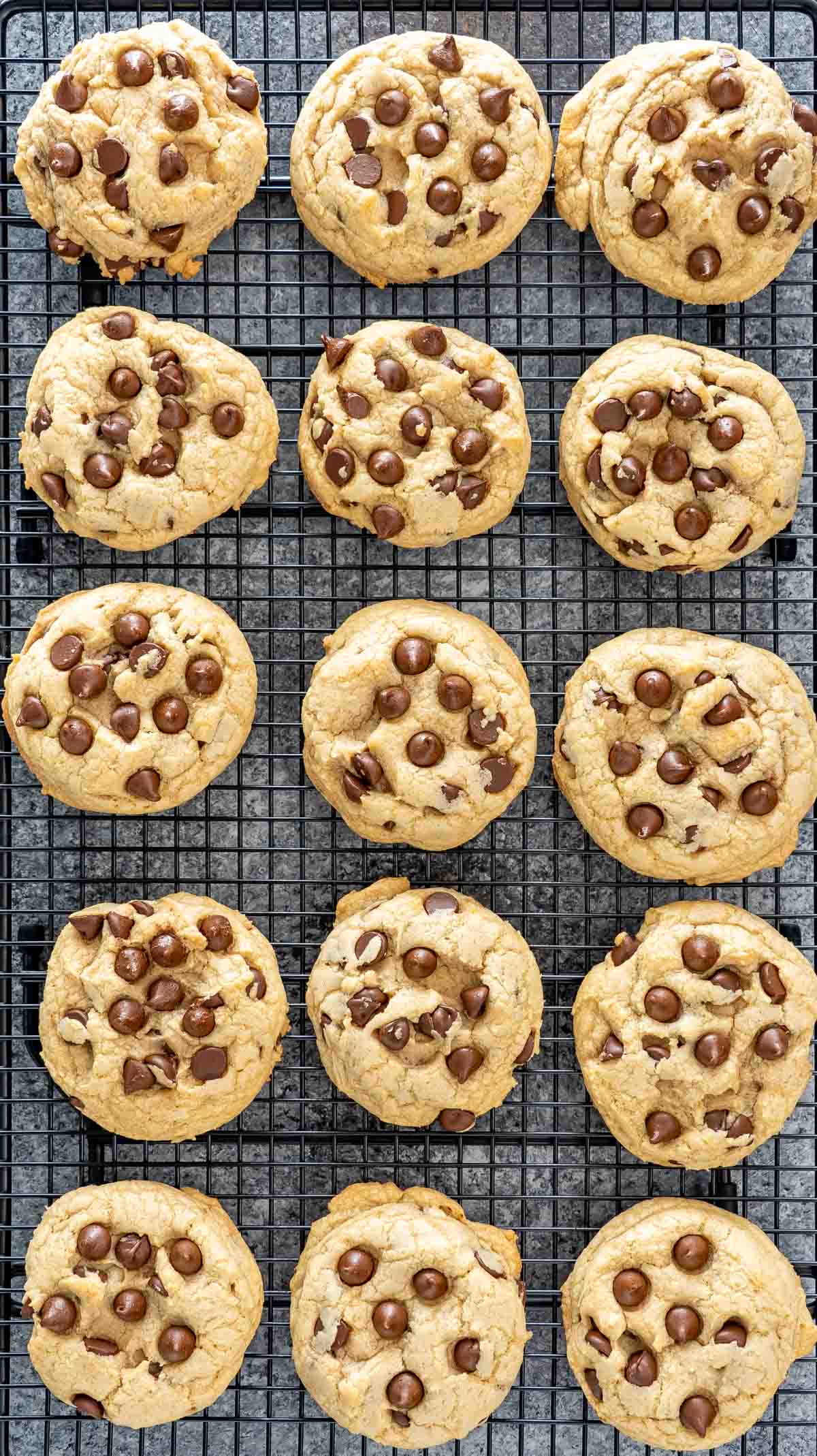 chocolate chip cookies on a black cooling rack.