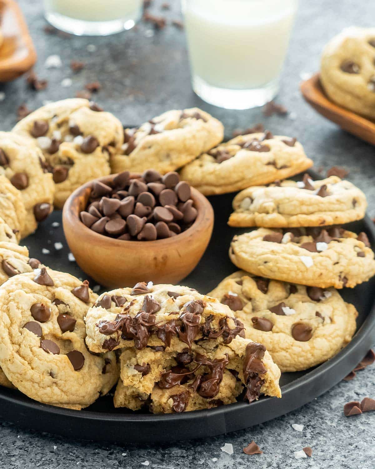 chocolate chip cookies on a black plate.