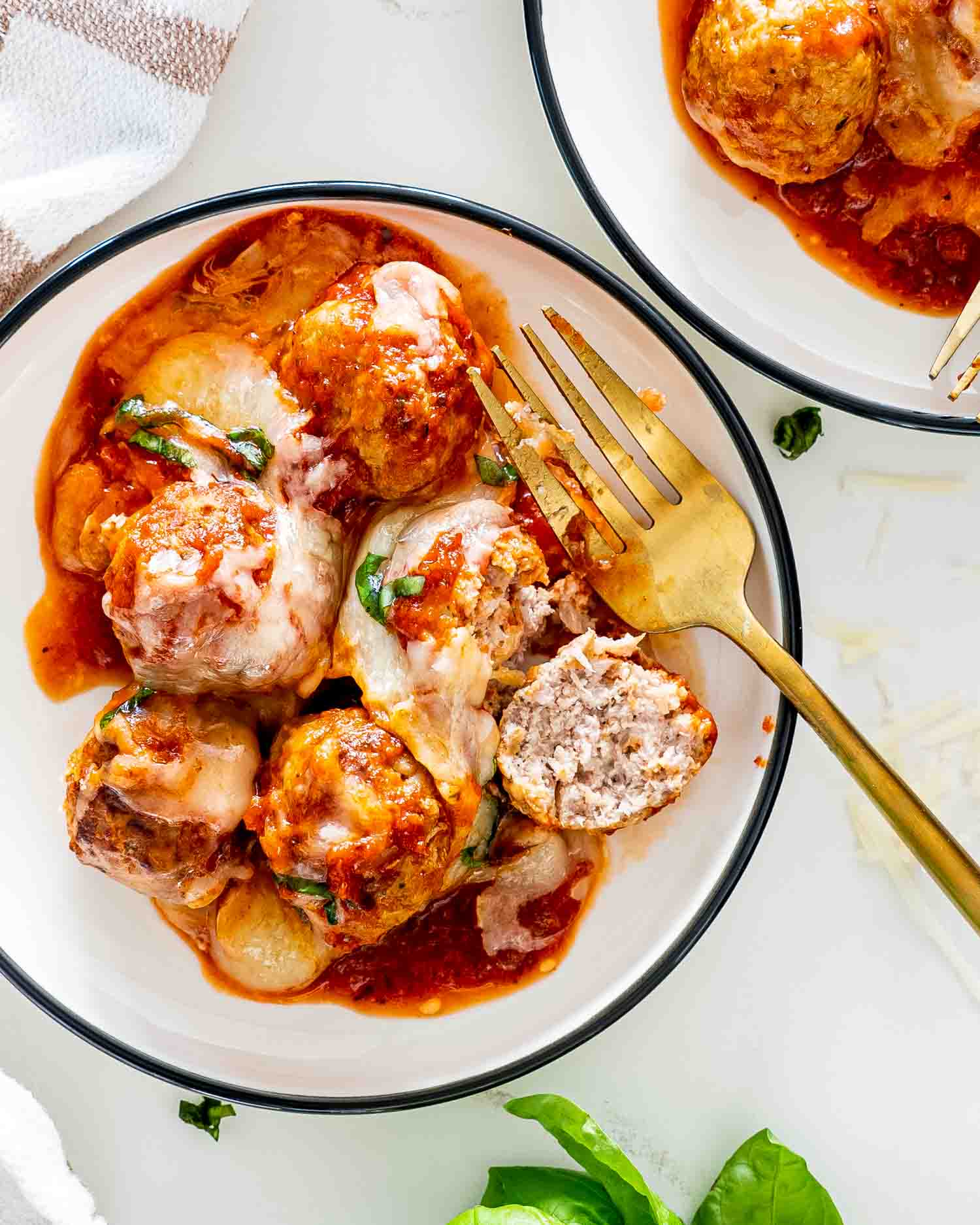 meatball parmesan on a white plate.