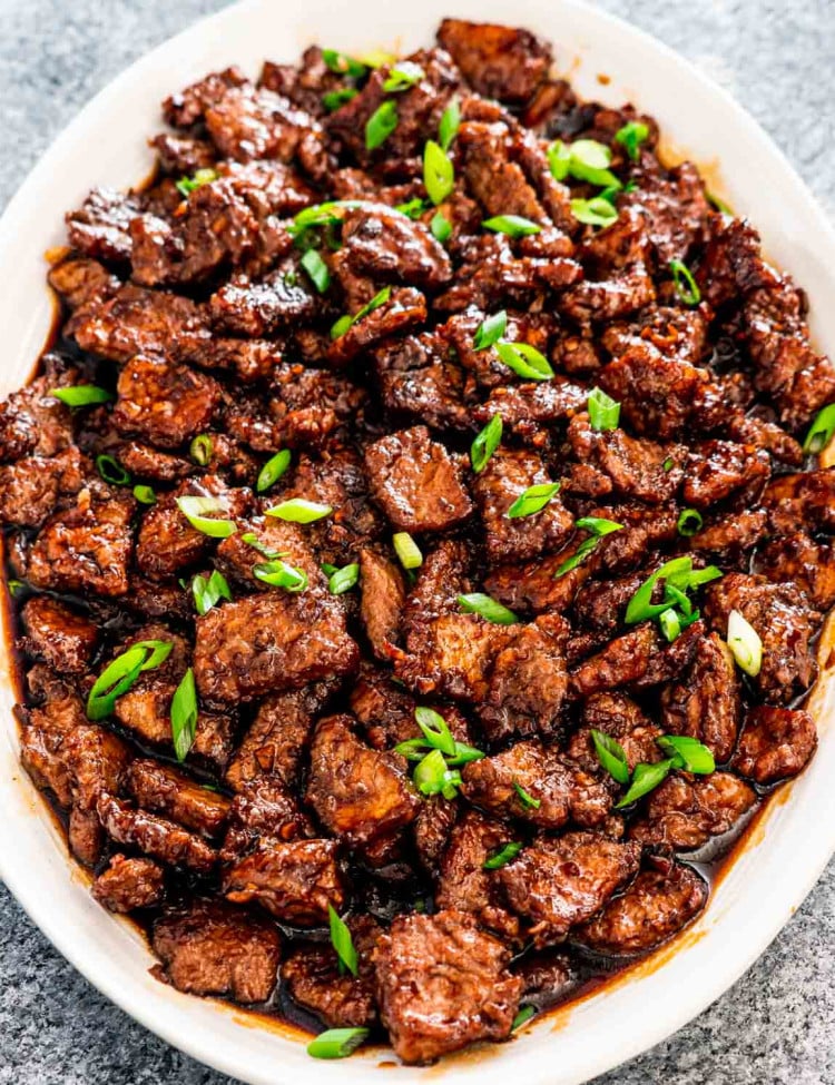 mongolian beef on a white serving platter.