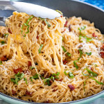 freshly made ramen carbonara in a skillet garnished with basil.