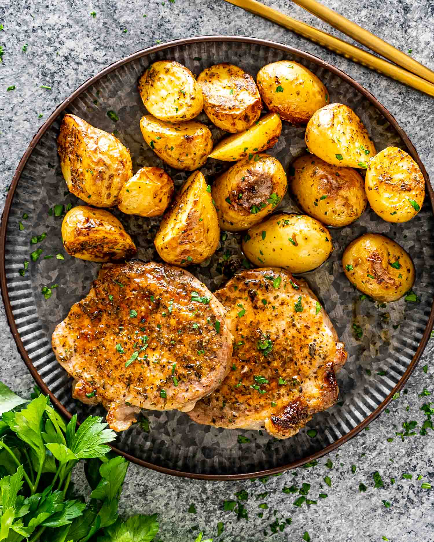 2 ranch pork chops and potatoes on a plate.
