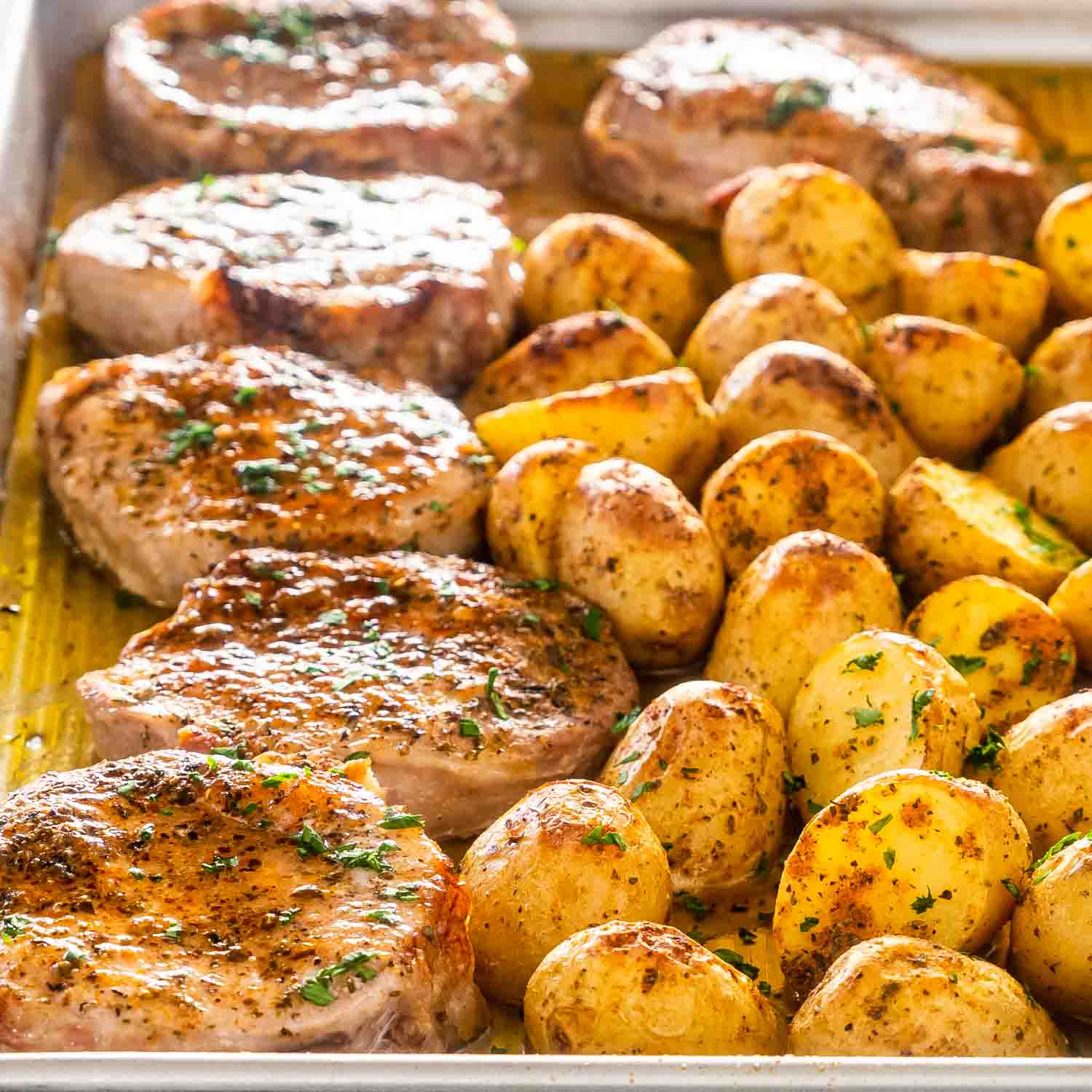 ranch pork chops and potatoes on a sheet pan.