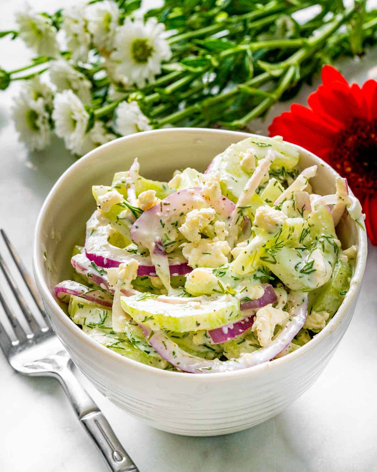 creamy cucumber salad in a small bowl.