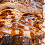sliced instant pot beef brisket covered in gravy