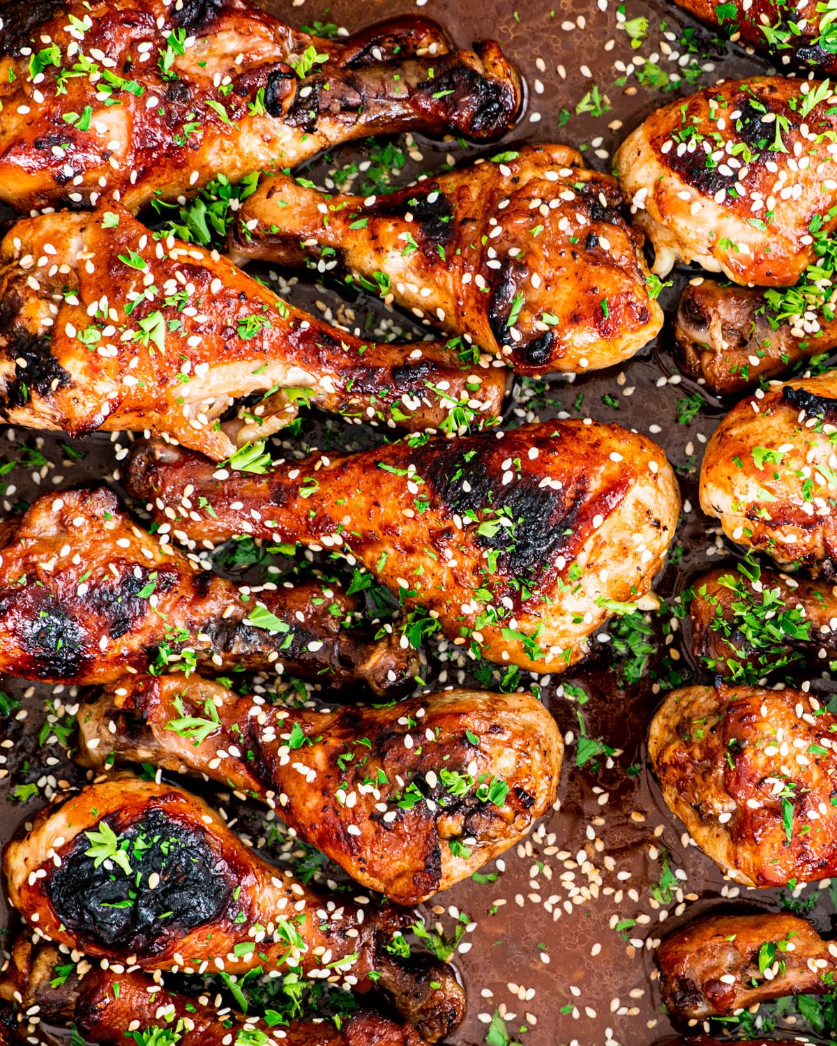 Korean BBQ Chicken in a baking dish garnished with sesame seeds with parsley