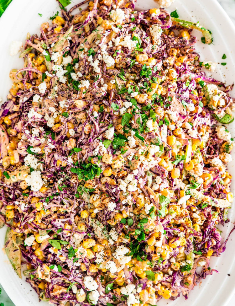 overhead shot of mexican street corn slaw on a large serving plate