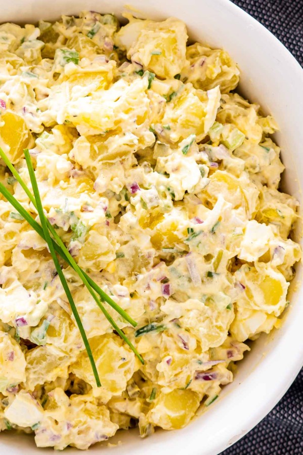 close up of potato salad in a white bowl.
