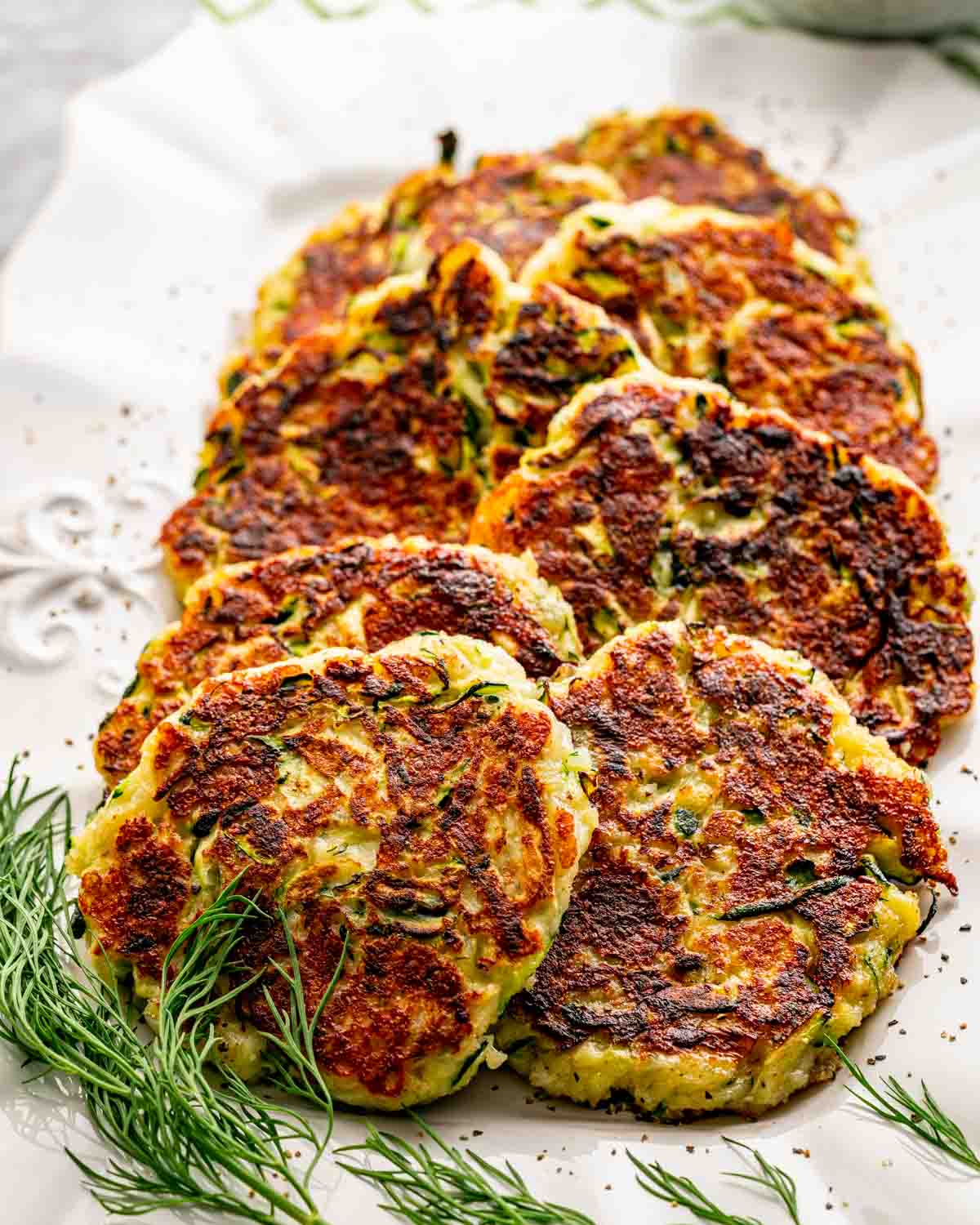 zucchini fritters on a serving platter.