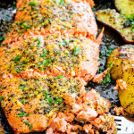 baked lemon pepper salmon with a piece being flaked by a fork