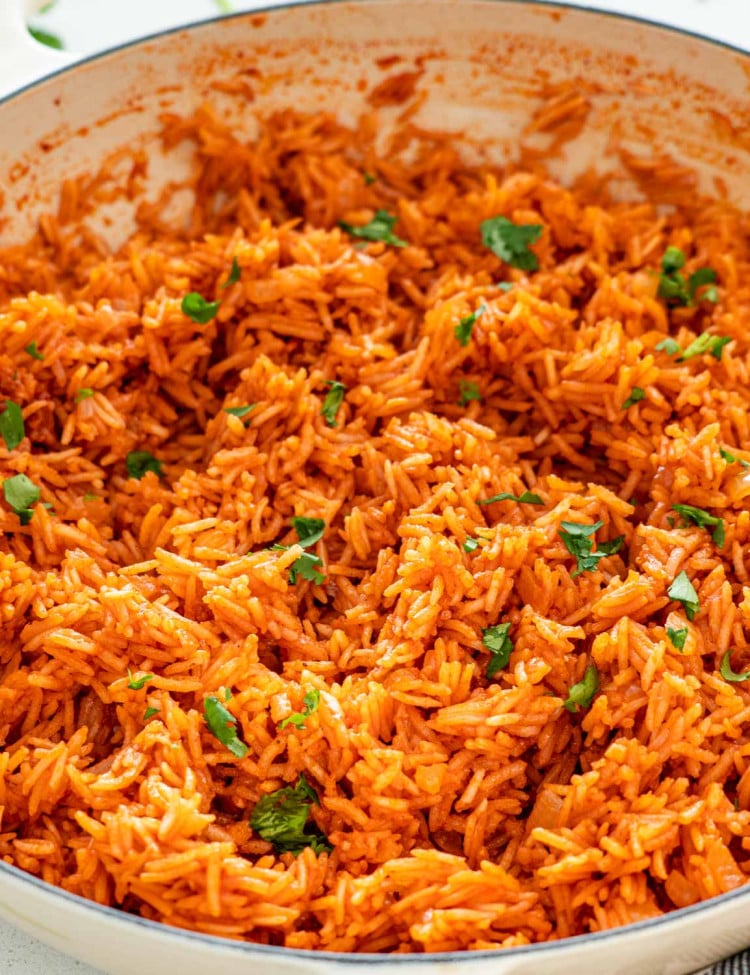 freshly made mexican rice in a skillet garnished with cilantro.