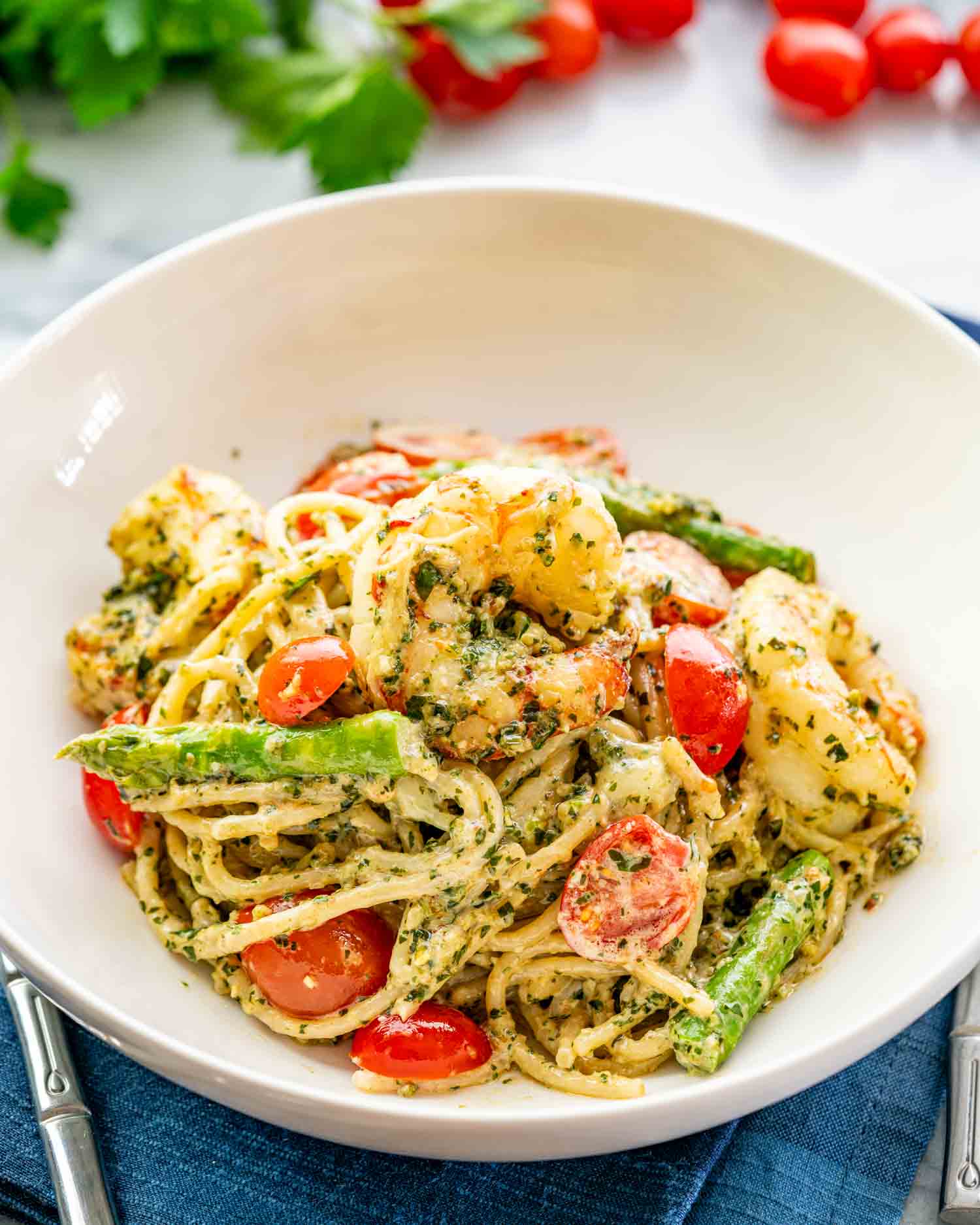 a serving of pesto shrimp asparagus pasta in a bowl.