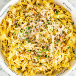 overhead shot of a bowl full of chanterelle mushrooms with tagliatelle