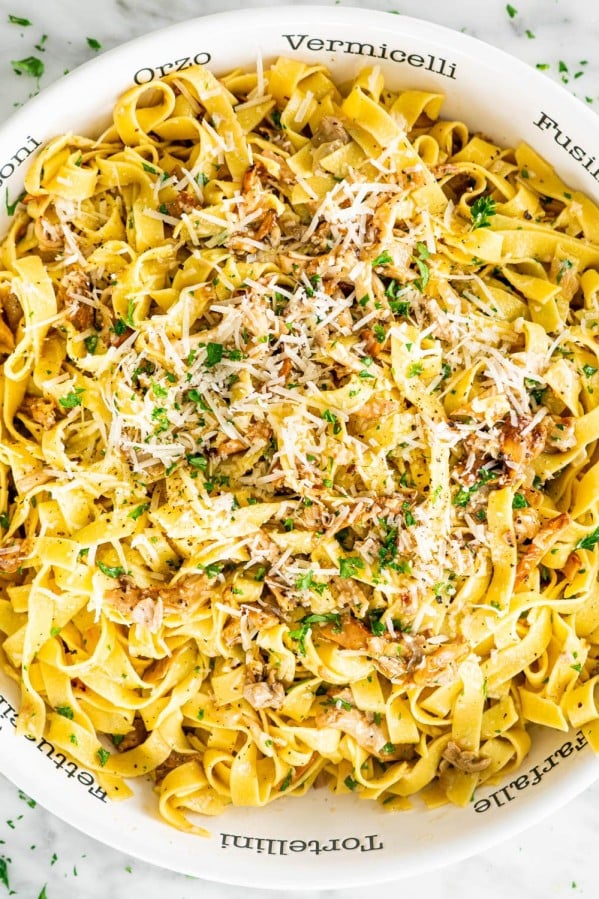 overhead shot of a bowl full of chanterelle mushrooms with tagliatelle