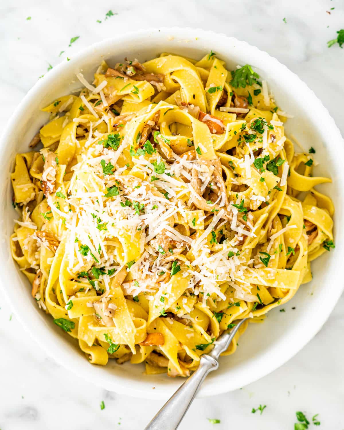 Chanterelle Mushrooms with Tagliatelle in a white bowl