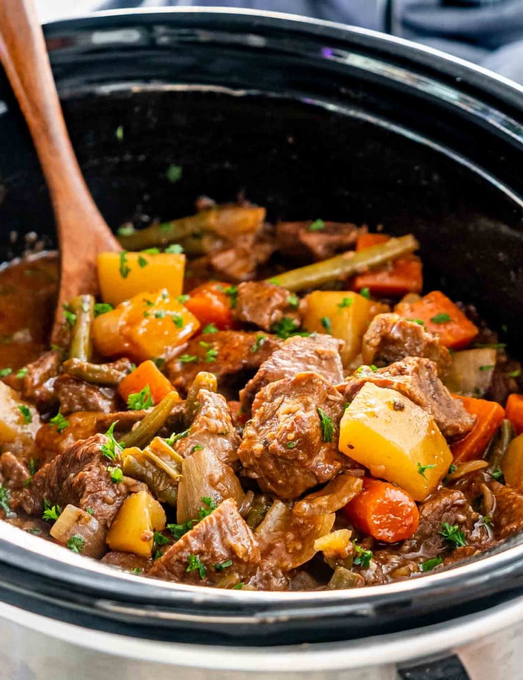 beef stew in a black crockpot.