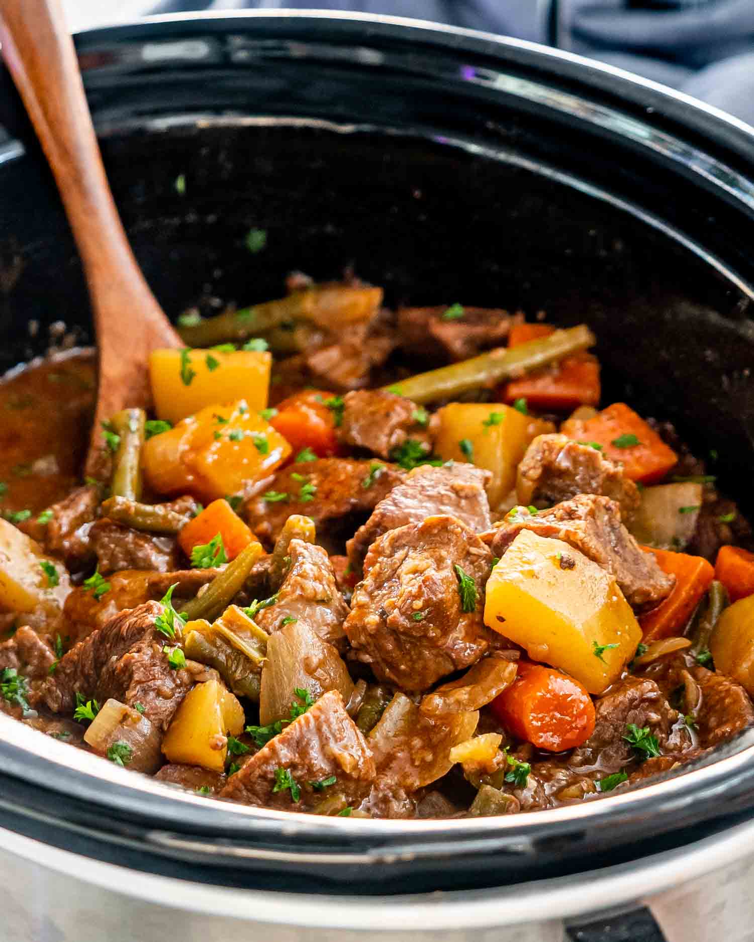 beef stew in a black crockpot.
