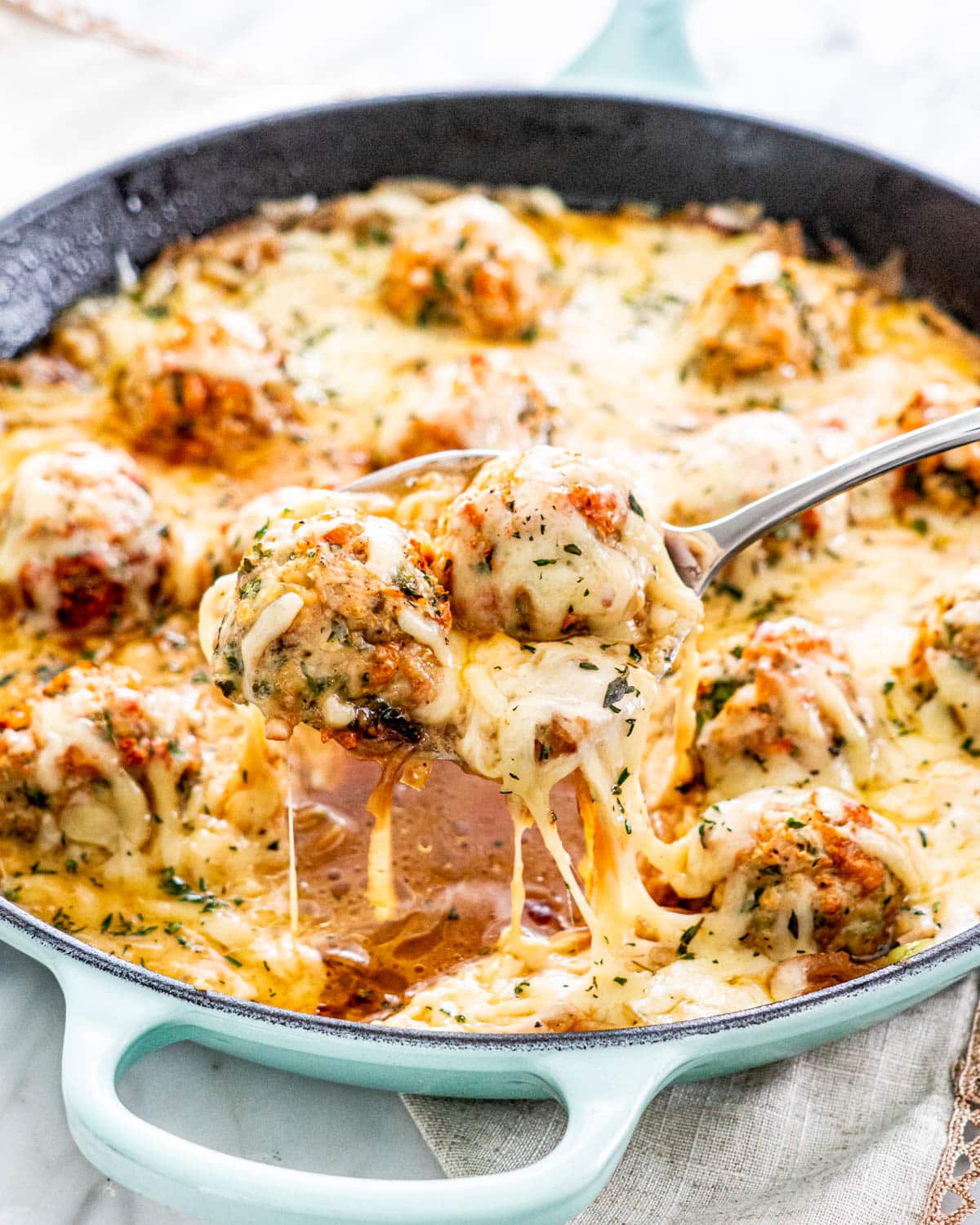 a blue skillet with French Onion Chicken Meatballs
