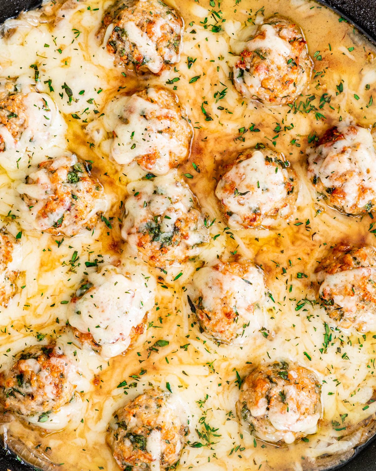 overhead shot of French Onion Chicken Meatballs in a skillet