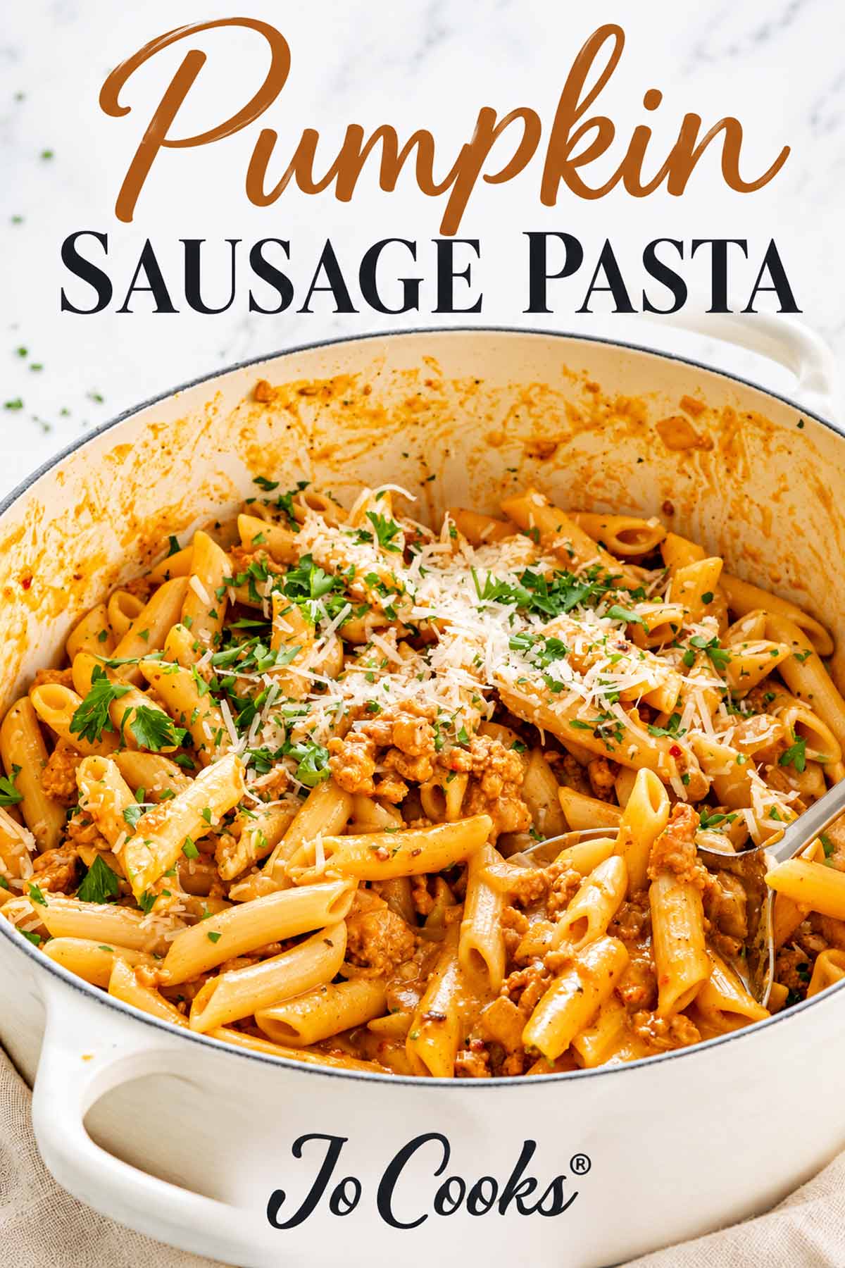 Pumpkin sausage pasta in a white Dutch oven beneath the recipe title, with Parmesan, parsley, and the Jo Cooks logo.