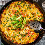 chicken tamale casserole in a black skillet.
