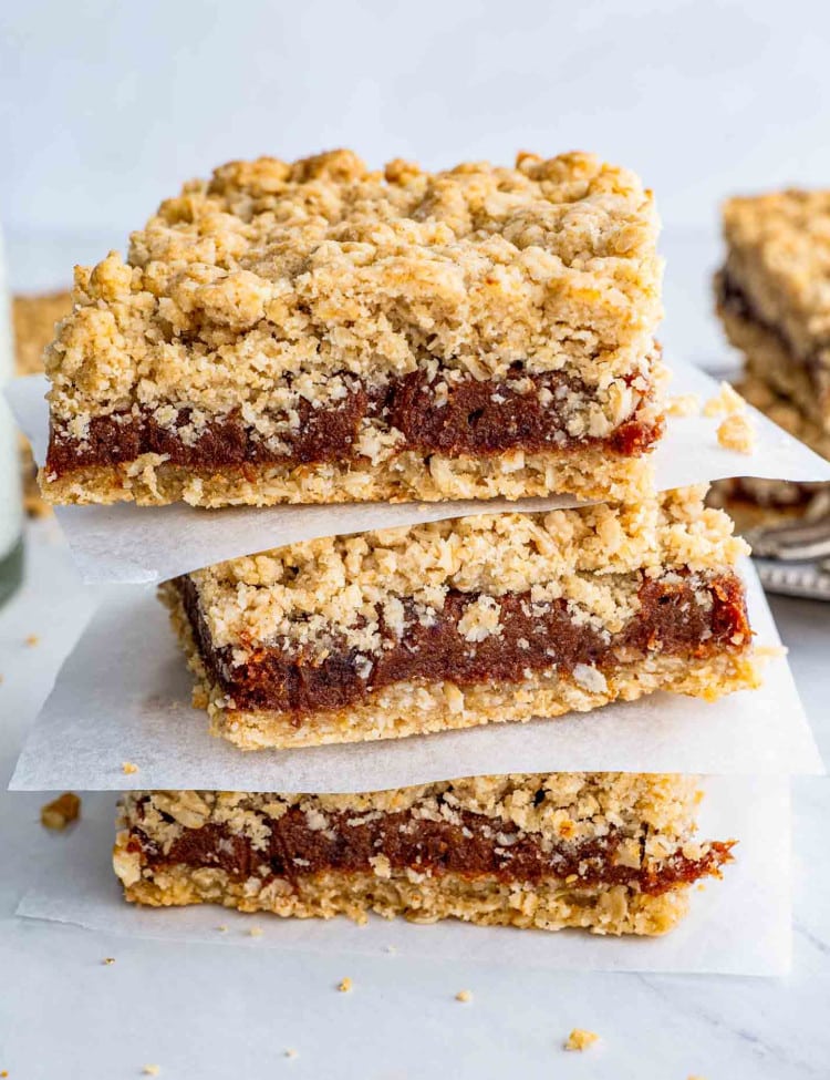 a stack of date squares on a plate.