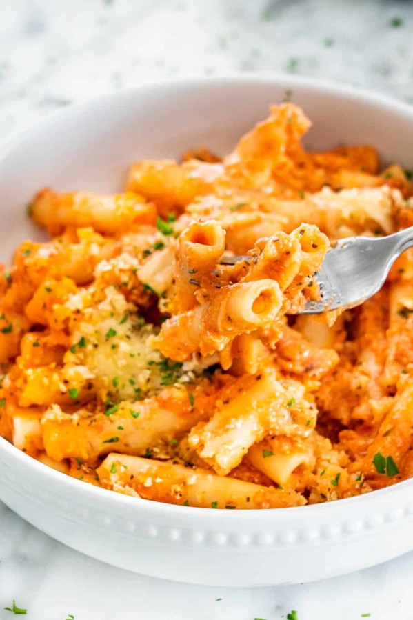 top shot of a fork holding up a bite of five cheese ziti al forno
