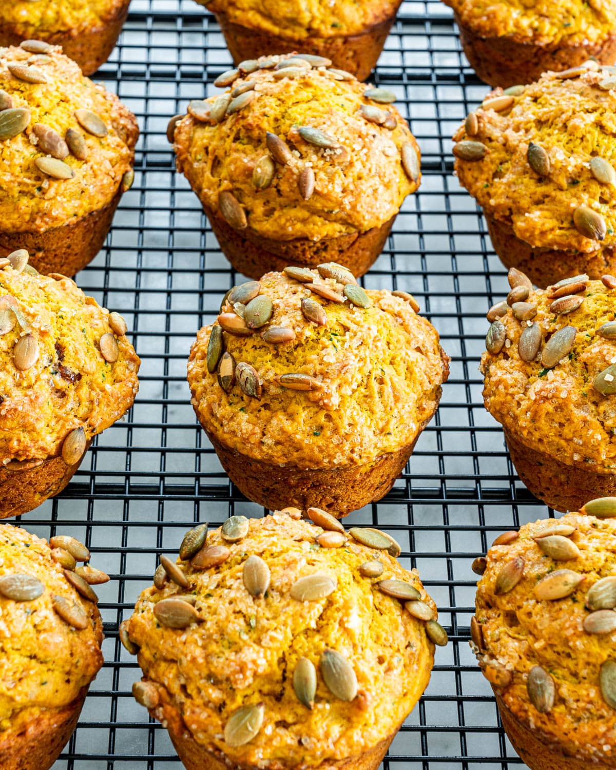 close up of Pumpkin Zucchini Muffins on a cooling rack