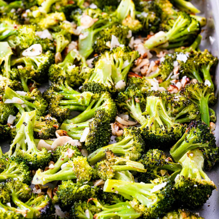 closeup of roasted broccoli on a baking sheet.