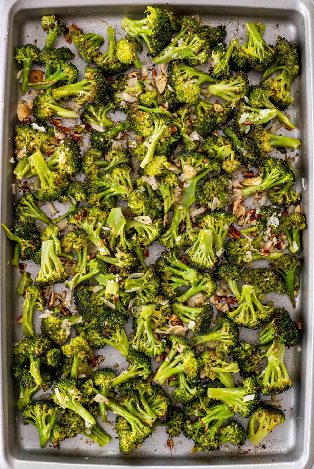 overhead shot of roasted broccoli on a baking sheet.