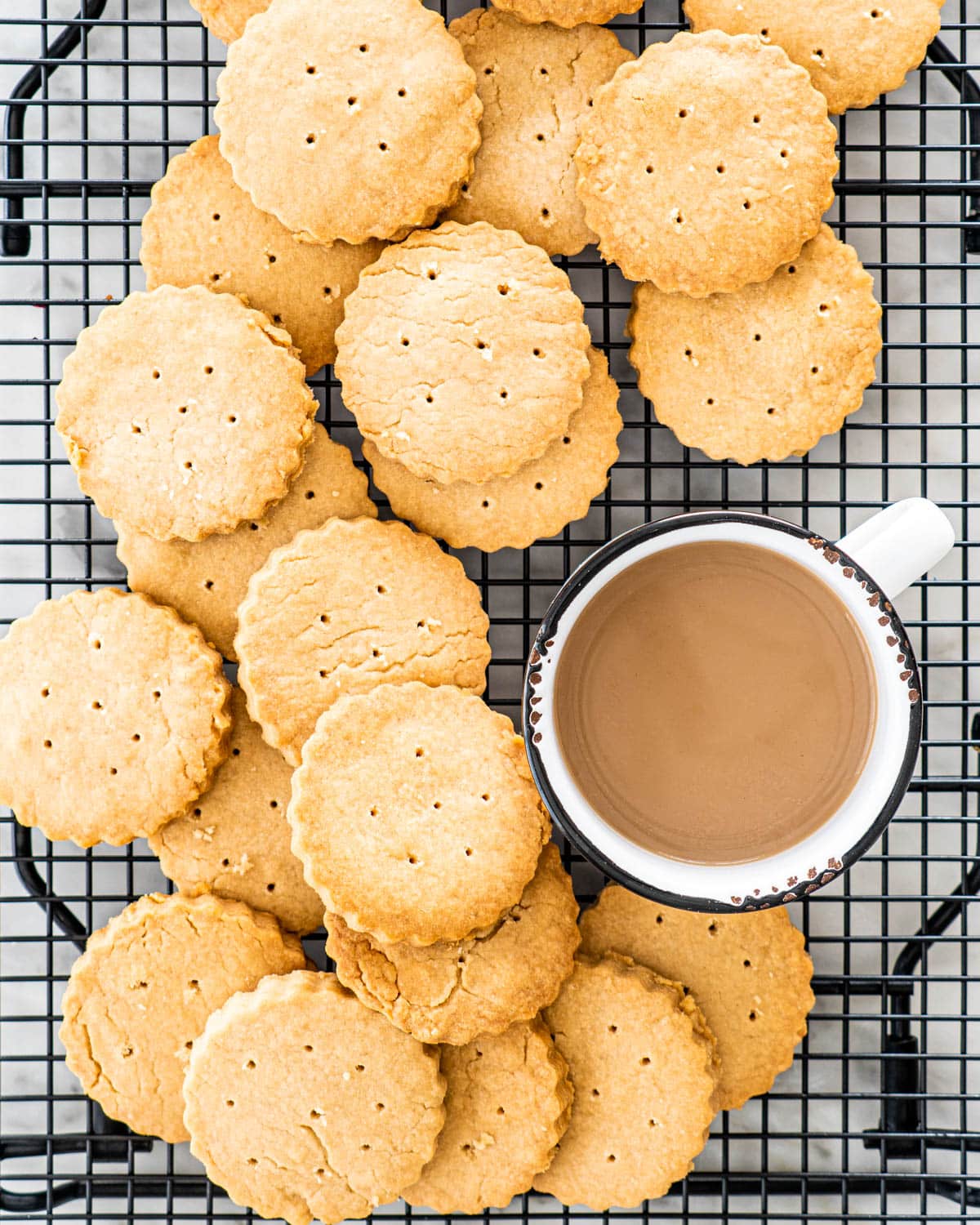 overhead shot of a bunch of Brown Sugar Scottish Shortbread on a cooling rack with a cup of coffee