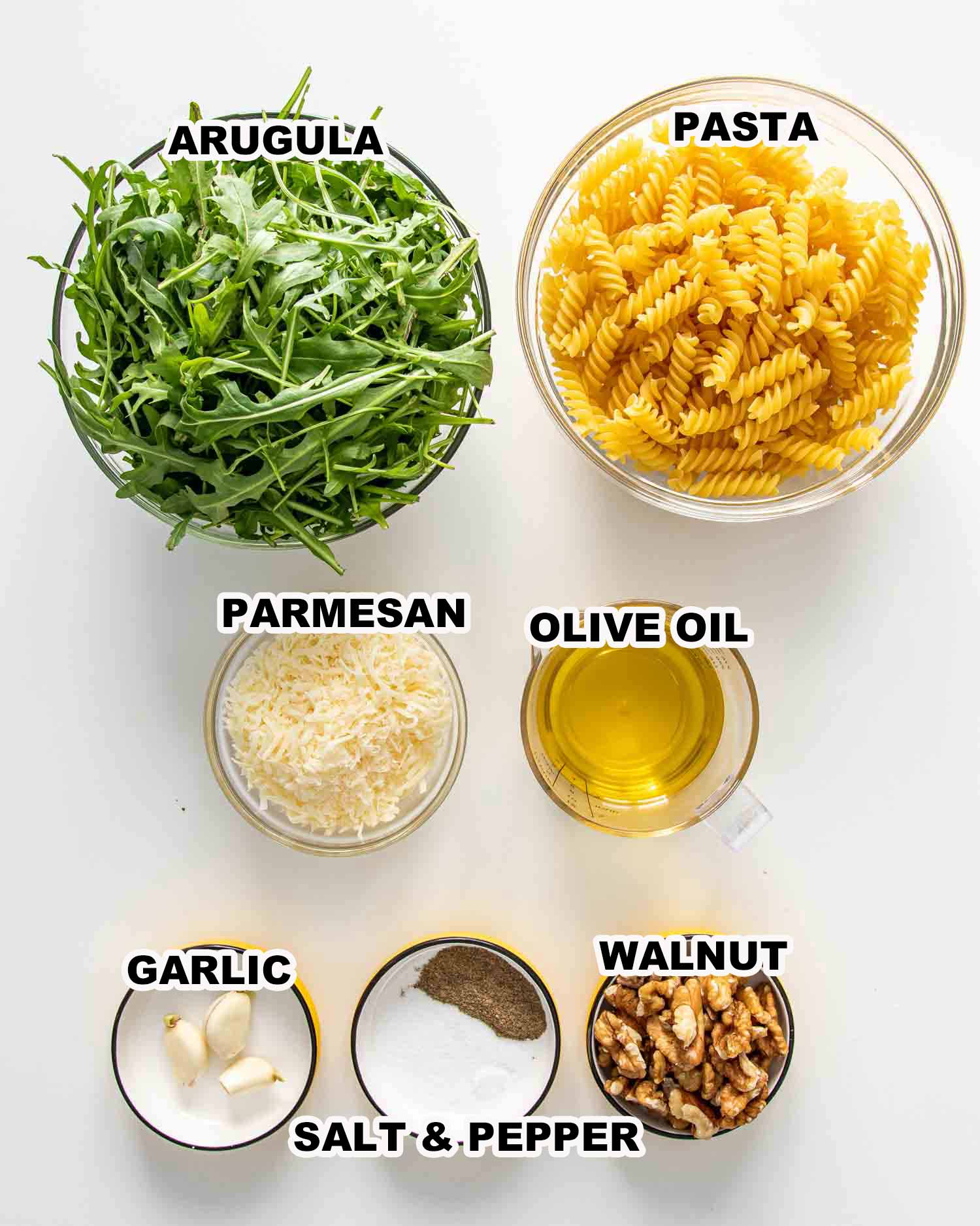 ingredients needed to make arugula walnut pesto pasta.