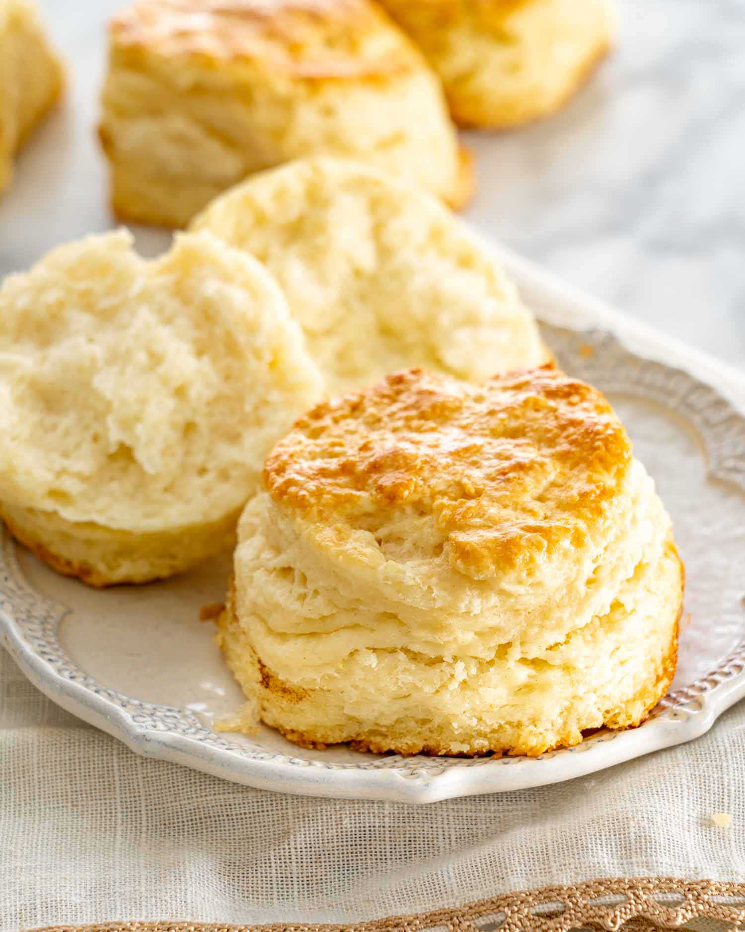 a couple buttermilk biscuits on a plate.