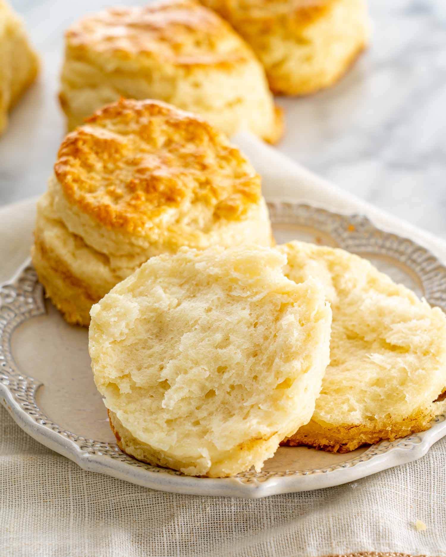 a couple buttermilk biscuits on a plate.