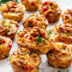 a few leftover ham and cheese breakfast muffins on a table garnished with some parsley.