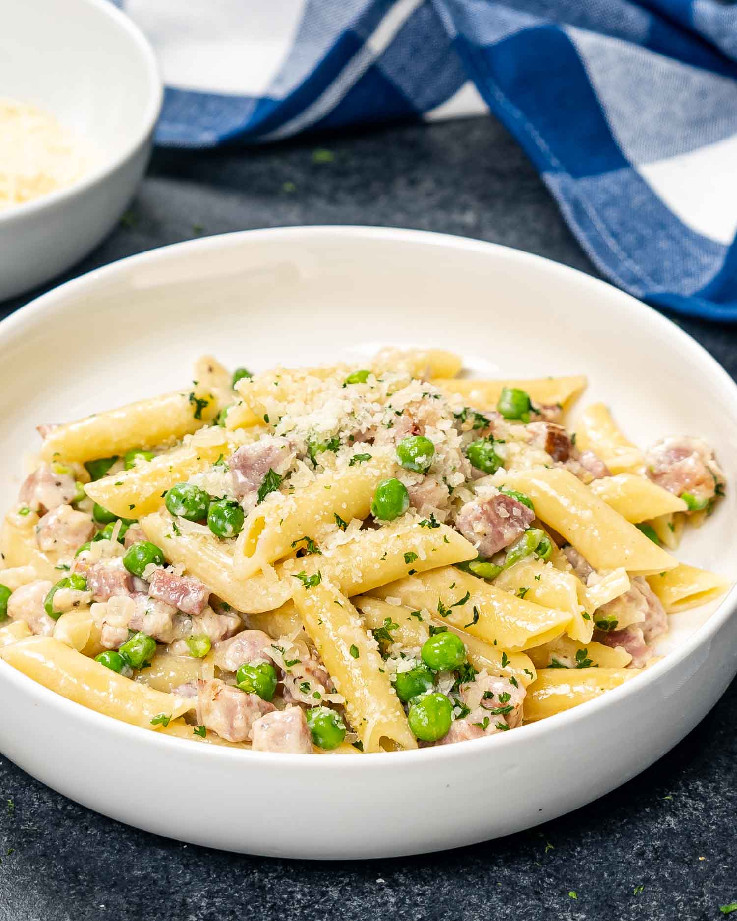 a serving of leftover ham and cheese penne in a white bowl.