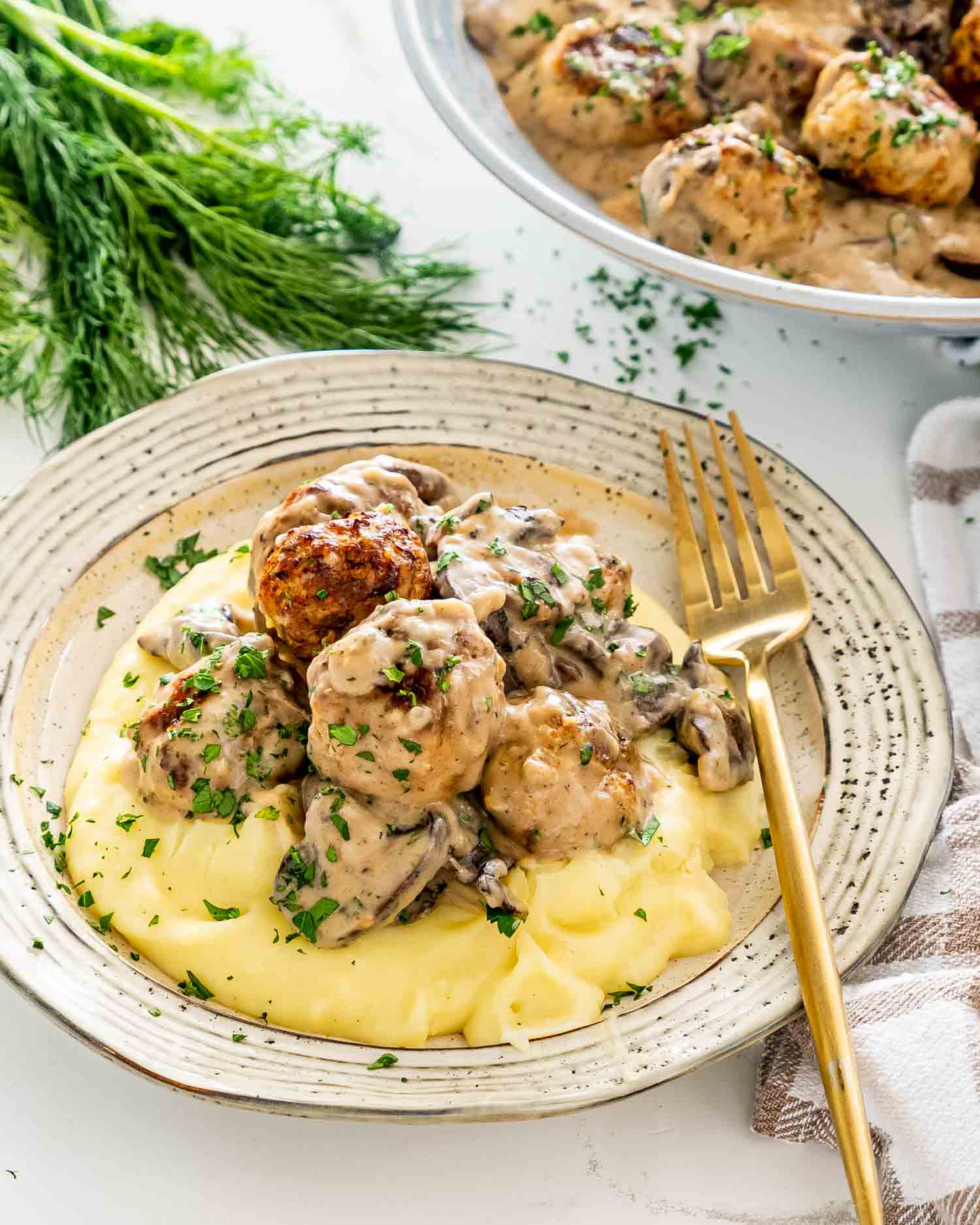 meatballs with mushroom gravy over a bed of mashed potatoes.