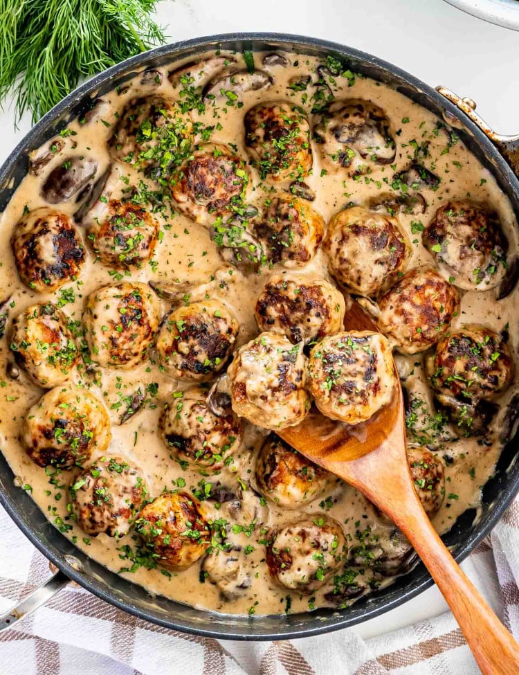 freshly made meatballs with mushroom gravy in a skillet.