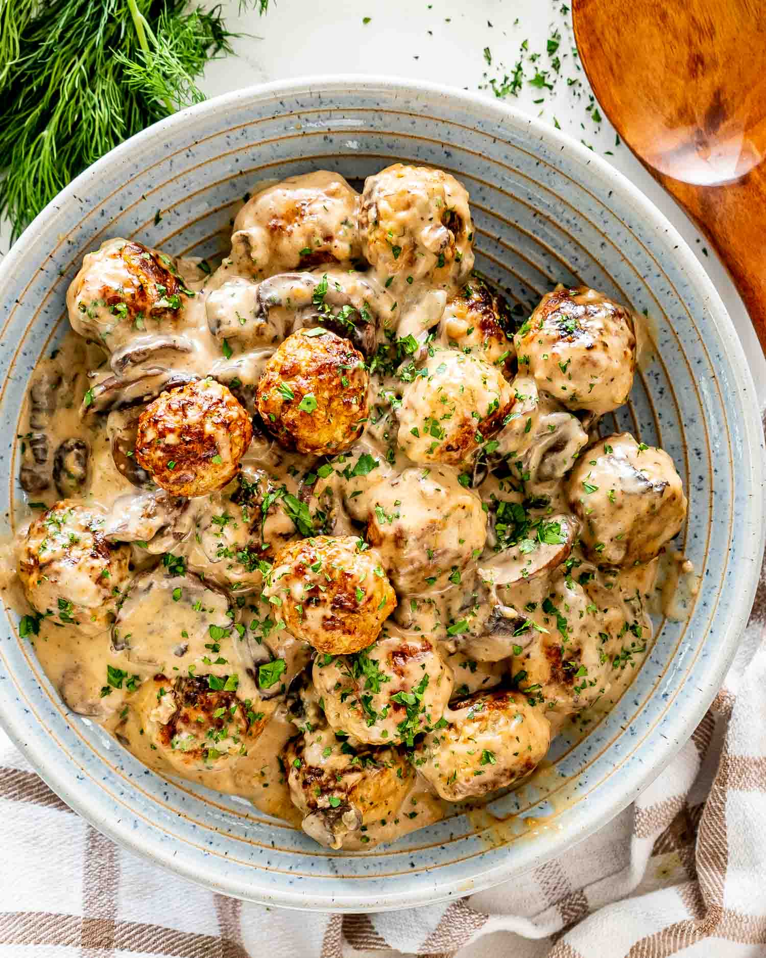 meatballs with mushrooms gravy in a bowl.