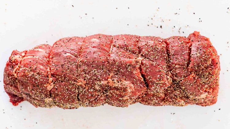 a 3 pound beef tenderloin seasoned with salt and pepper.