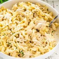 creamy ranch chicken that was made in an instant pot in a white serving bowl.