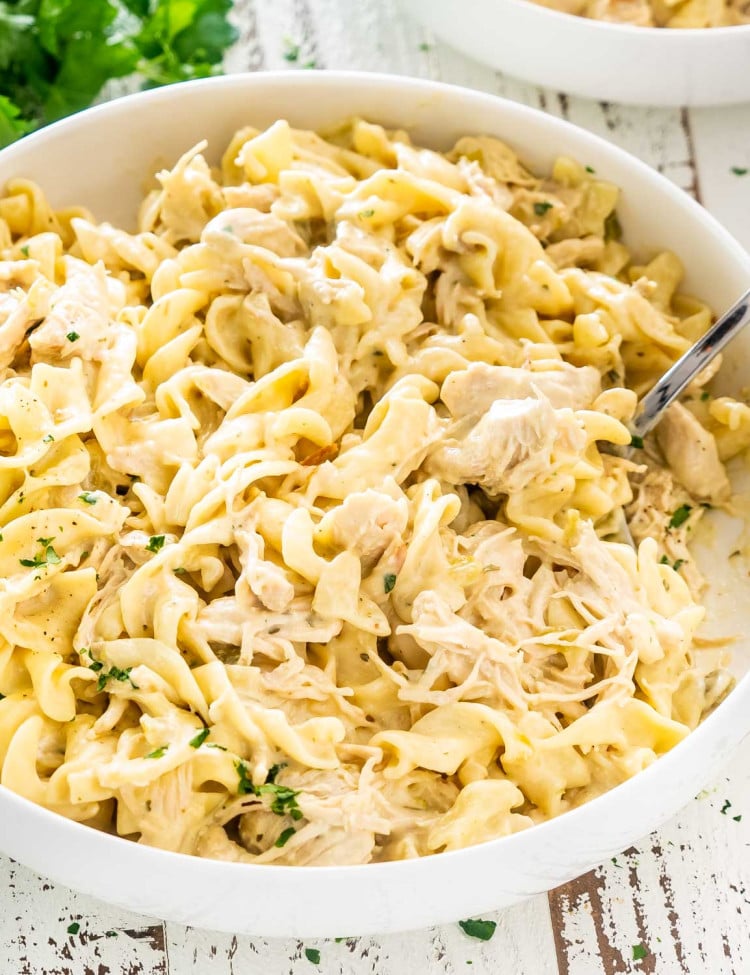 creamy ranch chicken that was made in an instant pot in a white serving bowl.