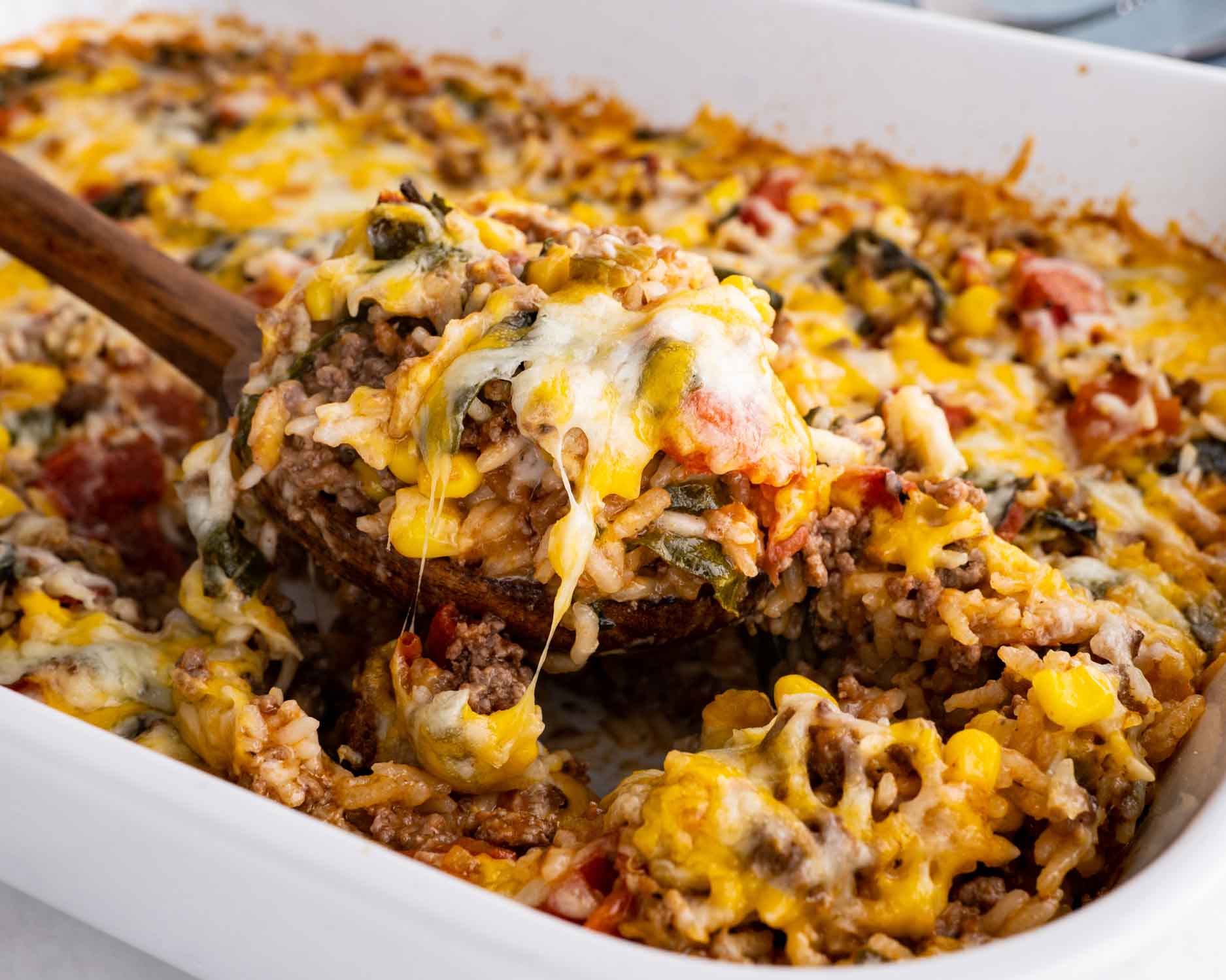 mexican beef and rice casserole in a white casserole dish.
