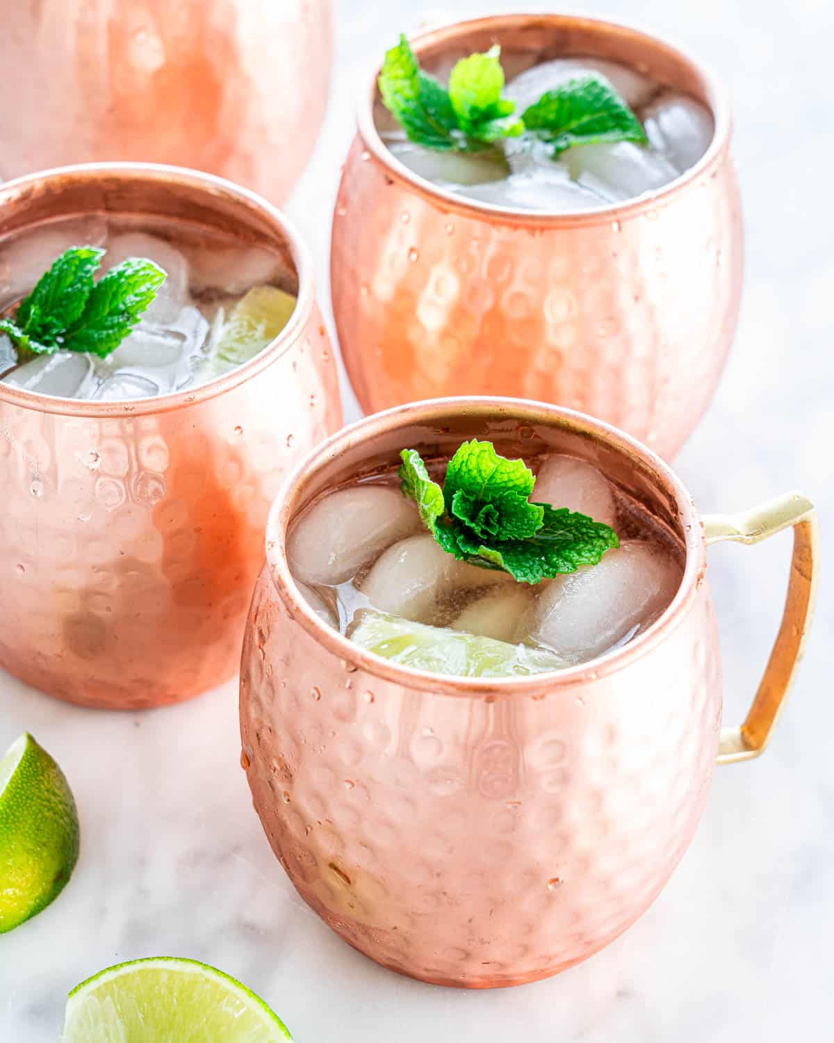 mowcow mule in 4 copper mugs garnished with mint