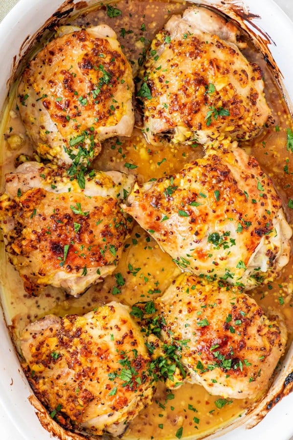 overhead shot of oven baked chicken thighs in a pan