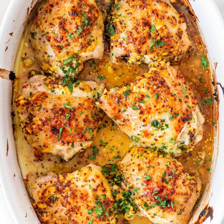 overhead shot of oven baked chicken thighs in a pan