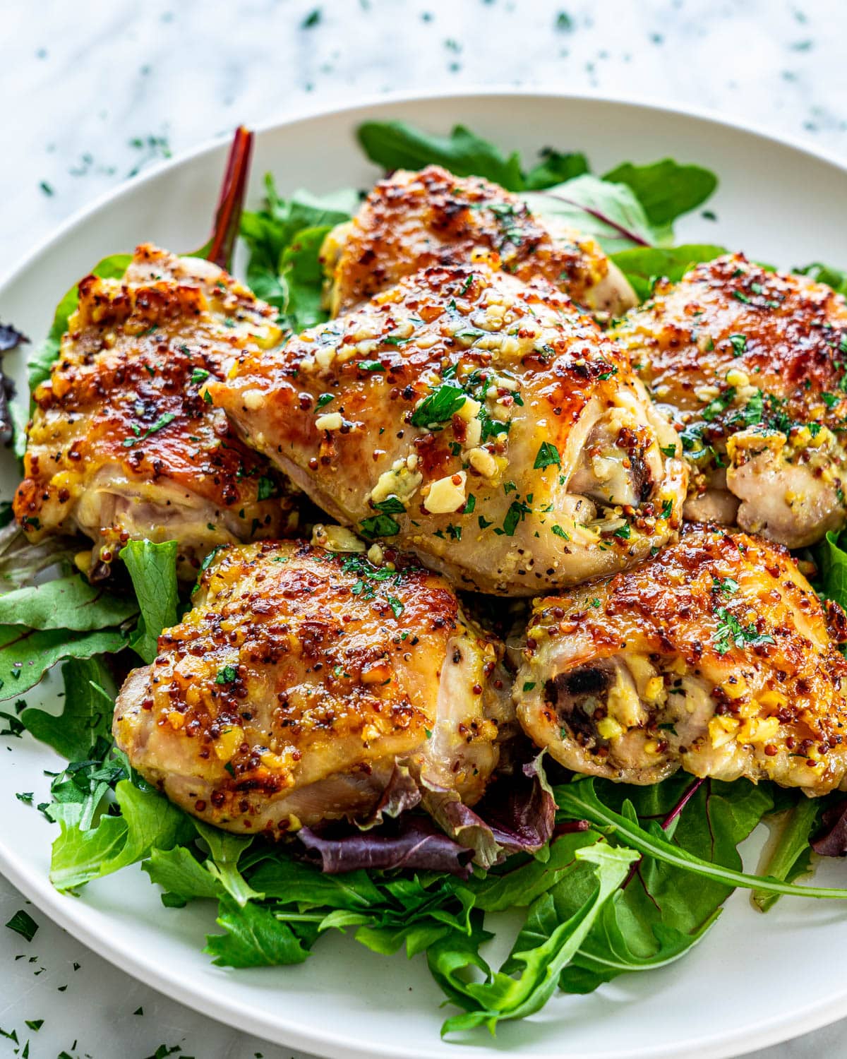 chicken thighs on a bed of arugula