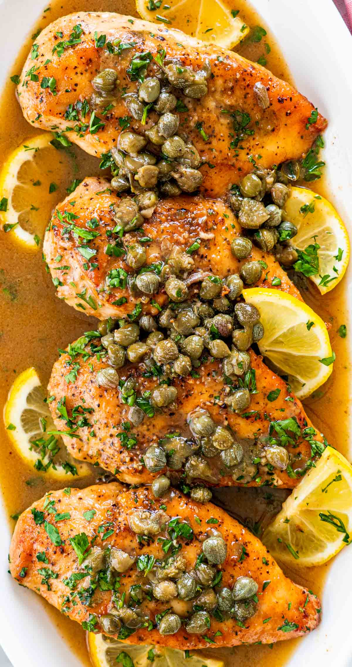 overhead shot of lemon chicken piccata on a serving platter.